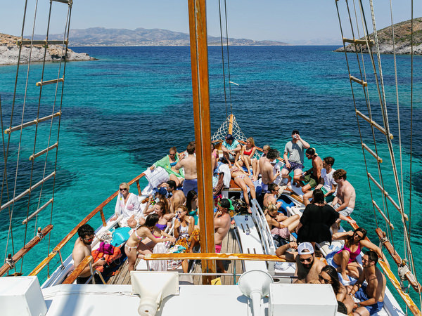 Guests cheering on boat deck during Antiparos cruise celebration