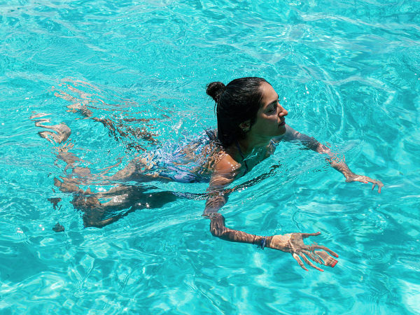 Guests swimming in clear blue water during Antiparos boat cruise