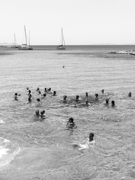 Guests swimming in clear blue water during Antiparos boat cruise