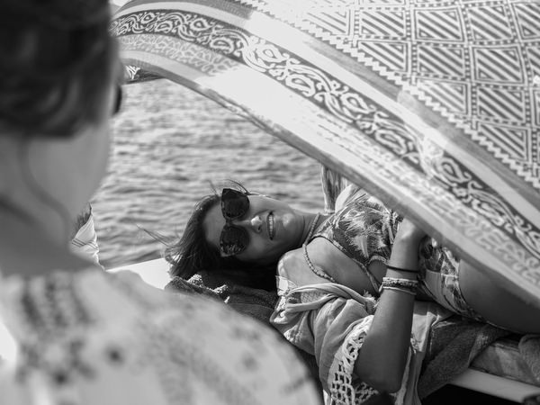 Friends relaxing together on boat deck during Antiparos cruise