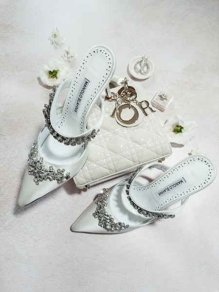 Bridal shoes and wedding jewelry arranged for an elegant Aegina wedding