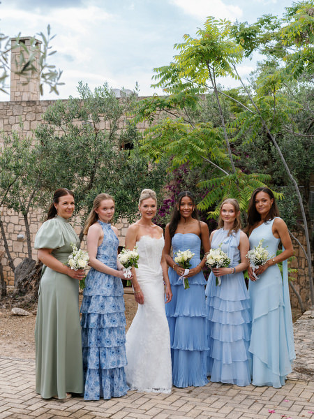 Bride with bridesmaids in blue dresses before the wedding ceremony in Aegina