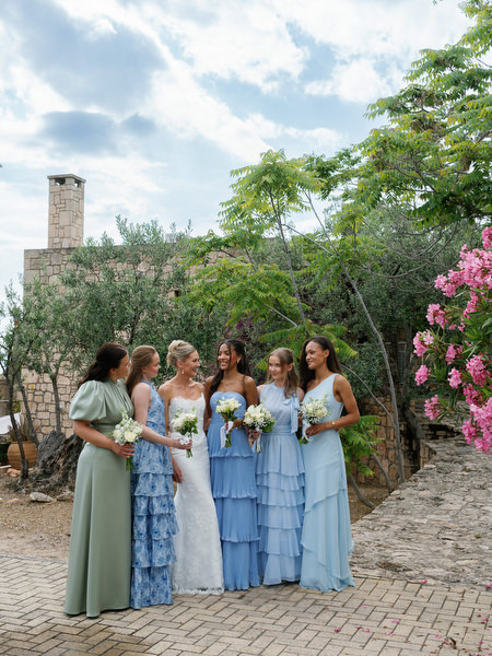 Bridal party portraits surrounded by olive trees and bougainvillea in Aegina