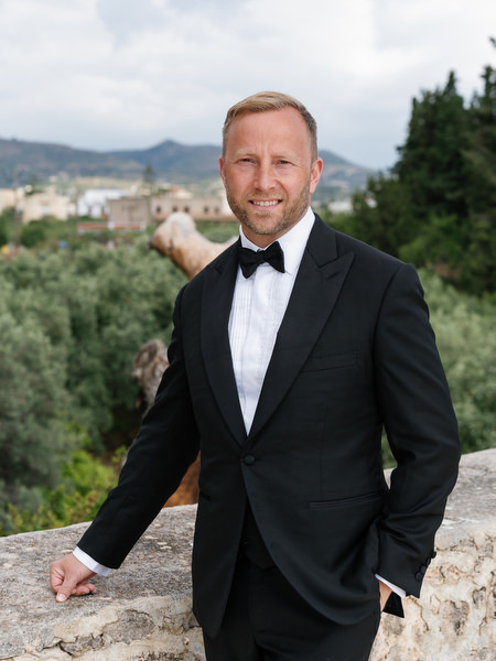 Groom portrait overlooking the Mediterranean landscape on Aegina island