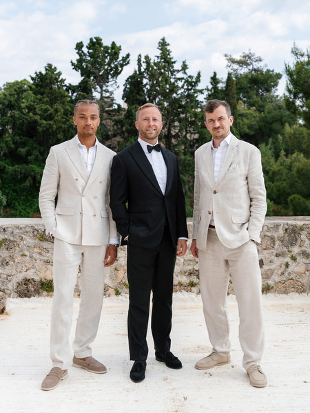 Groom standing with his groomsmen before the wedding ceremony at Pyrgos Ralli