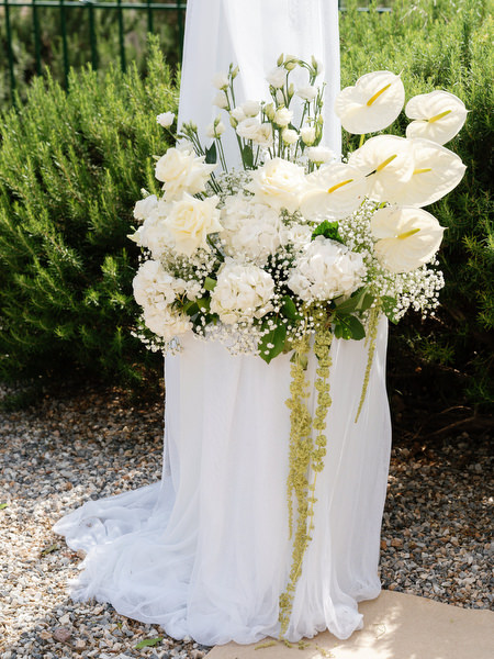Elegant white floral arrangement decorating the aisle at an Aegina wedding