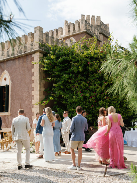 Guests arriving beside the historic Pyrgos Ralli tower for the wedding ceremony