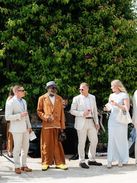 Wedding guests chatting before the ceremony during a Greek island wedding in Aegina