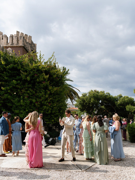 Guests gathering for Anne and Peter’s outdoor destination wedding ceremony in Aegina