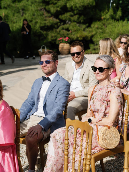 Wedding guests seated outdoors before the ceremony at Pyrgos Ralli in Aegina