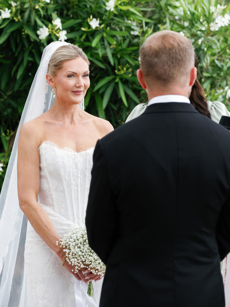 Bride and groom facing each other during their romantic Aegina wedding ceremony
