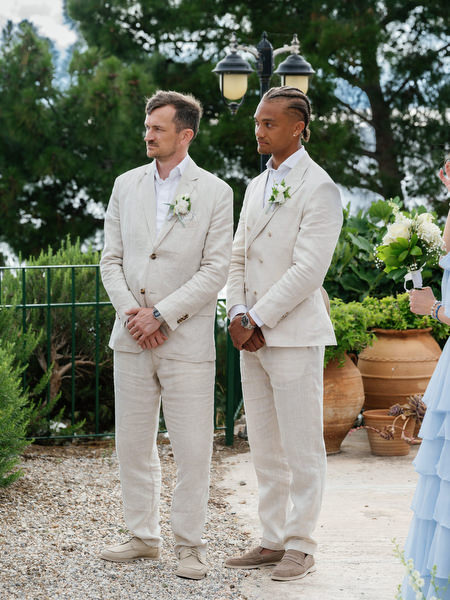 Groomsmen standing together at the altar during the outdoor ceremony in Aegina