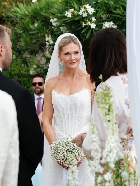 Bride smiling during the ceremony at her romantic Greek island wedding in Aegina