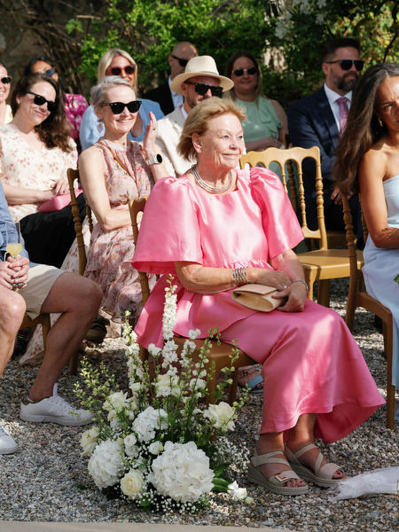 Wedding guest smiling during Anne and Peter’s outdoor ceremony at Pyrgos Ralli