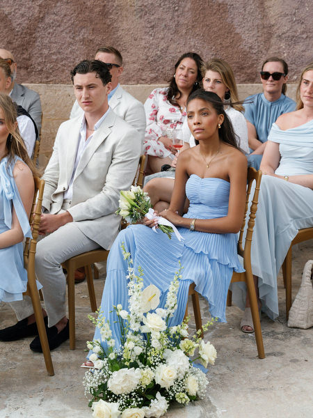 Wedding guests watching the ceremony beside the historic Pyrgos Ralli tower