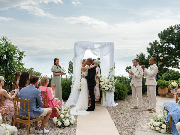 Bride and groom sharing a kiss after their romantic destination wedding ceremony