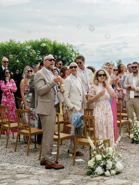 Wedding guests cheering the newlyweds after their outdoor ceremony at Pyrgos Ralli