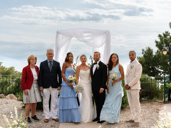 Bride and groom surrounded by family and friends after their Pyrgos Ralli ceremony