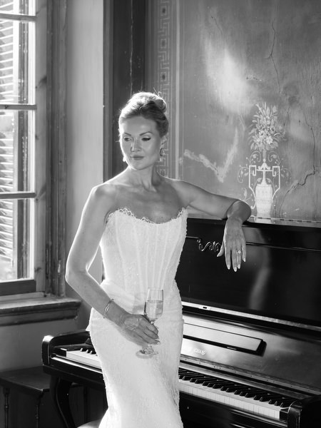 Black and white bridal portrait beside a piano inside Pyrgos Ralli