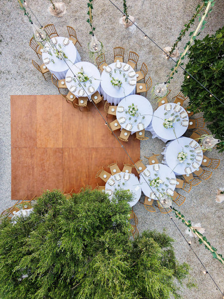 Wedding seating plan details arranged on a wooden board with floral accents