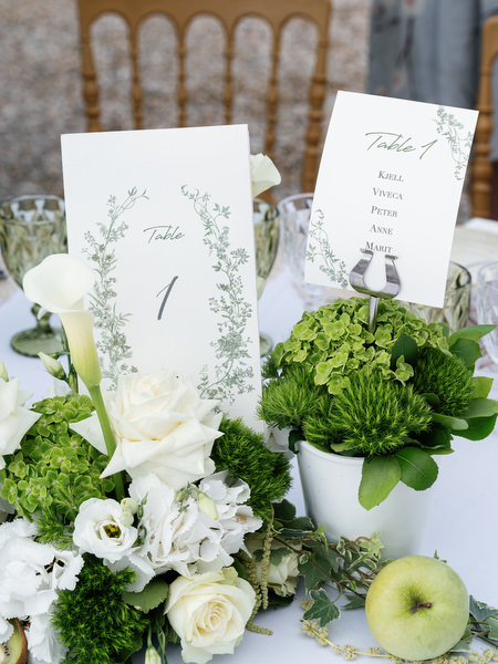 Wedding menu cards and floral table details for an elegant Greek island reception