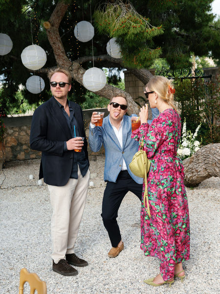 Wedding guests walking through the reception area during cocktail hour in Aegina