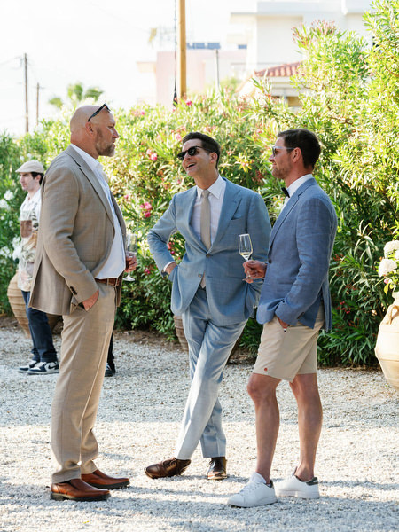 Wedding guests chatting during cocktail hour at a destination wedding in Aegina