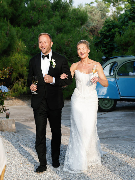 Bride and groom walking together during their relaxed Pyrgos Ralli wedding reception