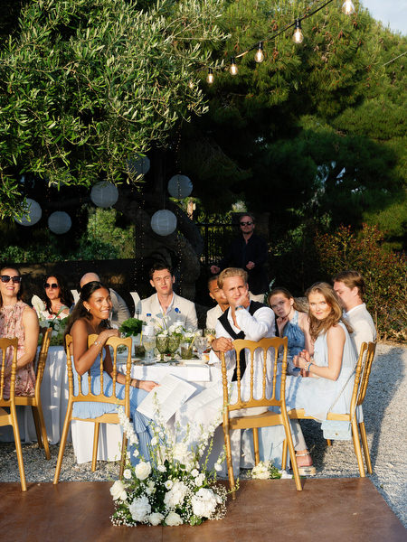Guests seated beneath trees during the elegant Pyrgos Ralli wedding dinner