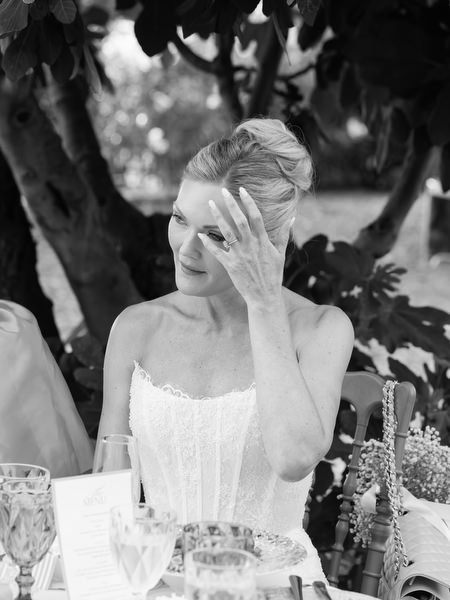 Black and white candid of the bride reacting emotionally during wedding speeches
