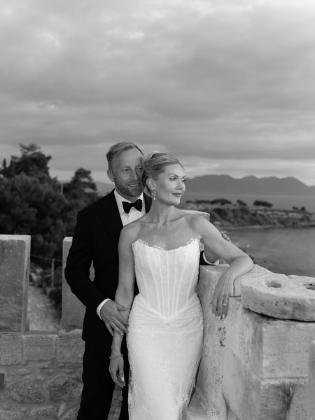 Black and white wedding portrait of the couple overlooking the sea in Aegina