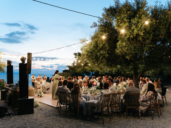 Elegant al fresco wedding dinner overlooking the sea during a Greek island wedding