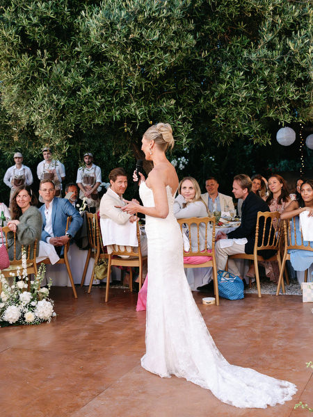 Bride giving a speech during the outdoor wedding reception in Aegina
