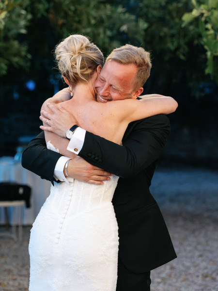 Bride and groom embracing emotionally during their evening wedding celebration