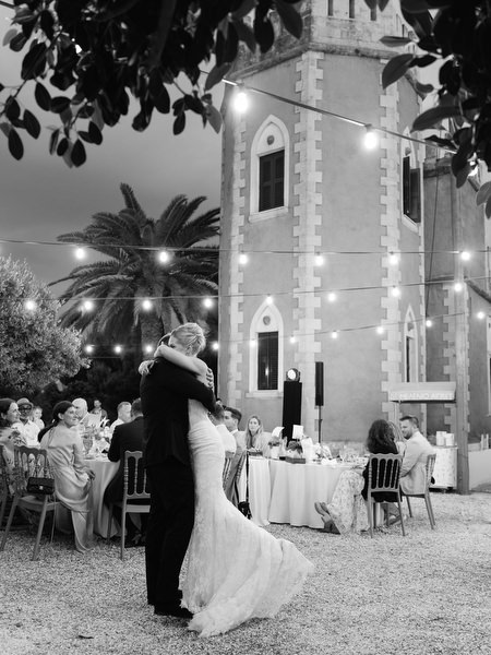 Black and white view of the illuminated Pyrgos Ralli tower during the wedding dinner