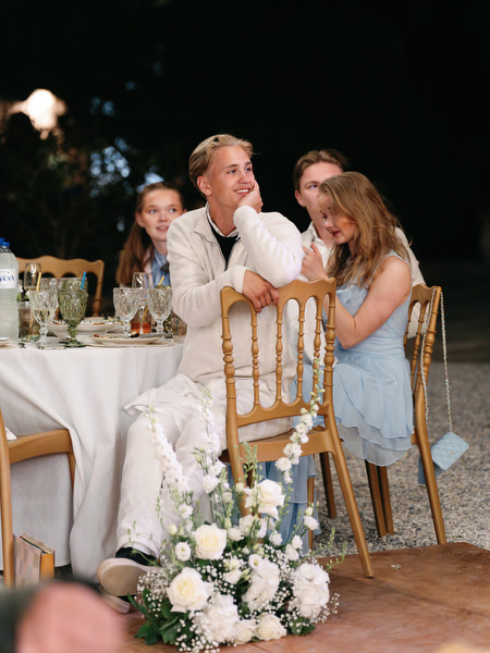 Wedding guest giving a heartfelt speech during the outdoor reception in Aegina