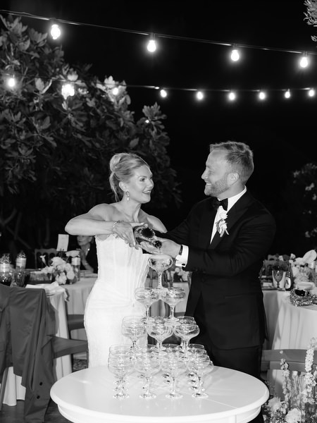 Black and white photo of the bride and groom cutting their wedding cake