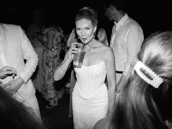 Black and white candid of the bride enjoying the lively wedding dance floor