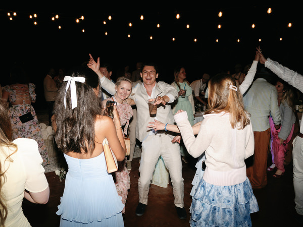 Guests dancing together during Anne and Peter’s energetic Greek island wedding party