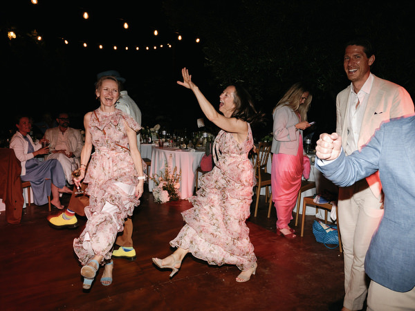 Guests dancing and laughing during the late-night Pyrgos Ralli wedding celebration