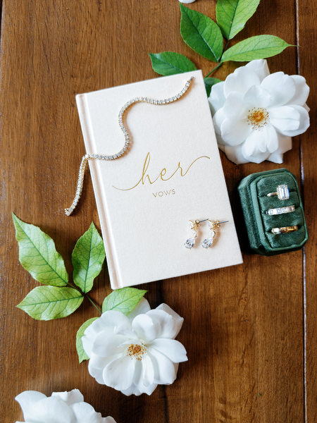 Elegant wedding vows and bridal details styled with white flowers