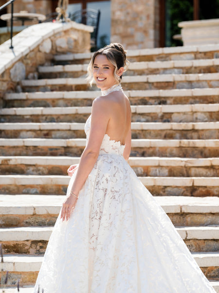 Elegant bridal portrait on the stone steps of Pyrgos Petreza near Athens
