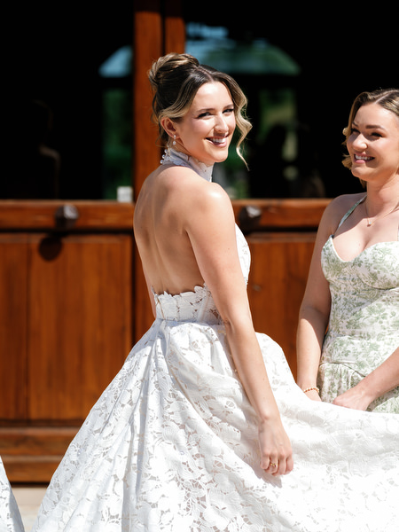 Bride smiling beside a bridesmaid during portraits at Pyrgos Petreza