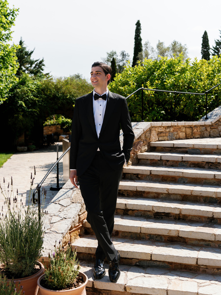 Groom posing alone on the stone staircase at Pyrgos Petreza