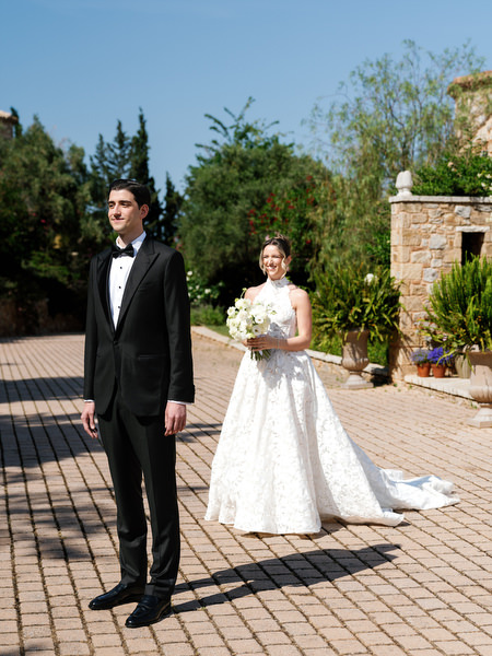 Bride and groom standing apart before their first look at Pyrgos Petreza