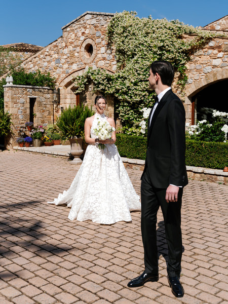 Bride approaching the groom for their first look in the courtyard at Pyrgos Petreza