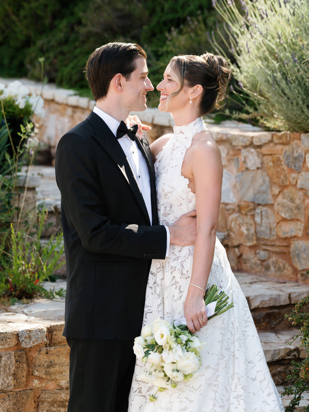 Bride and groom smiling together during portraits in the Mediterranean gardens