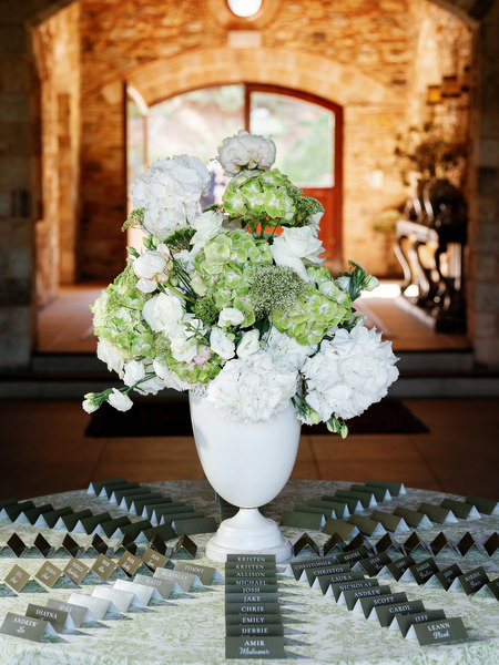 White floral wedding arrangement displayed inside the rustic stone interior