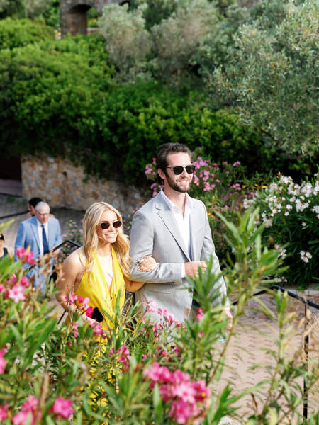 Wedding guest walking through the gardens before the outdoor ceremony at Pyrgos Petreza