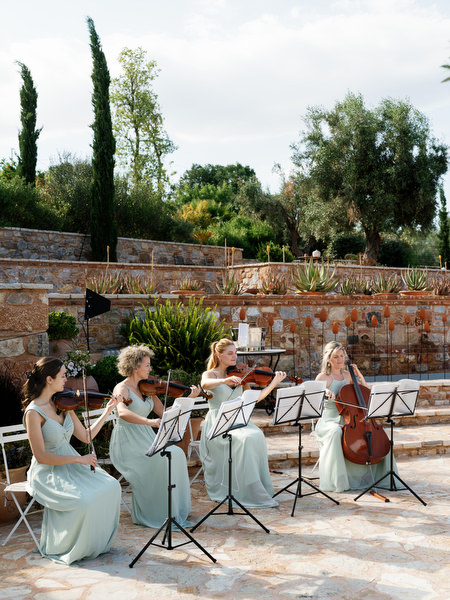 Musicians performing beside the ceremony space at the Athens countryside wedding